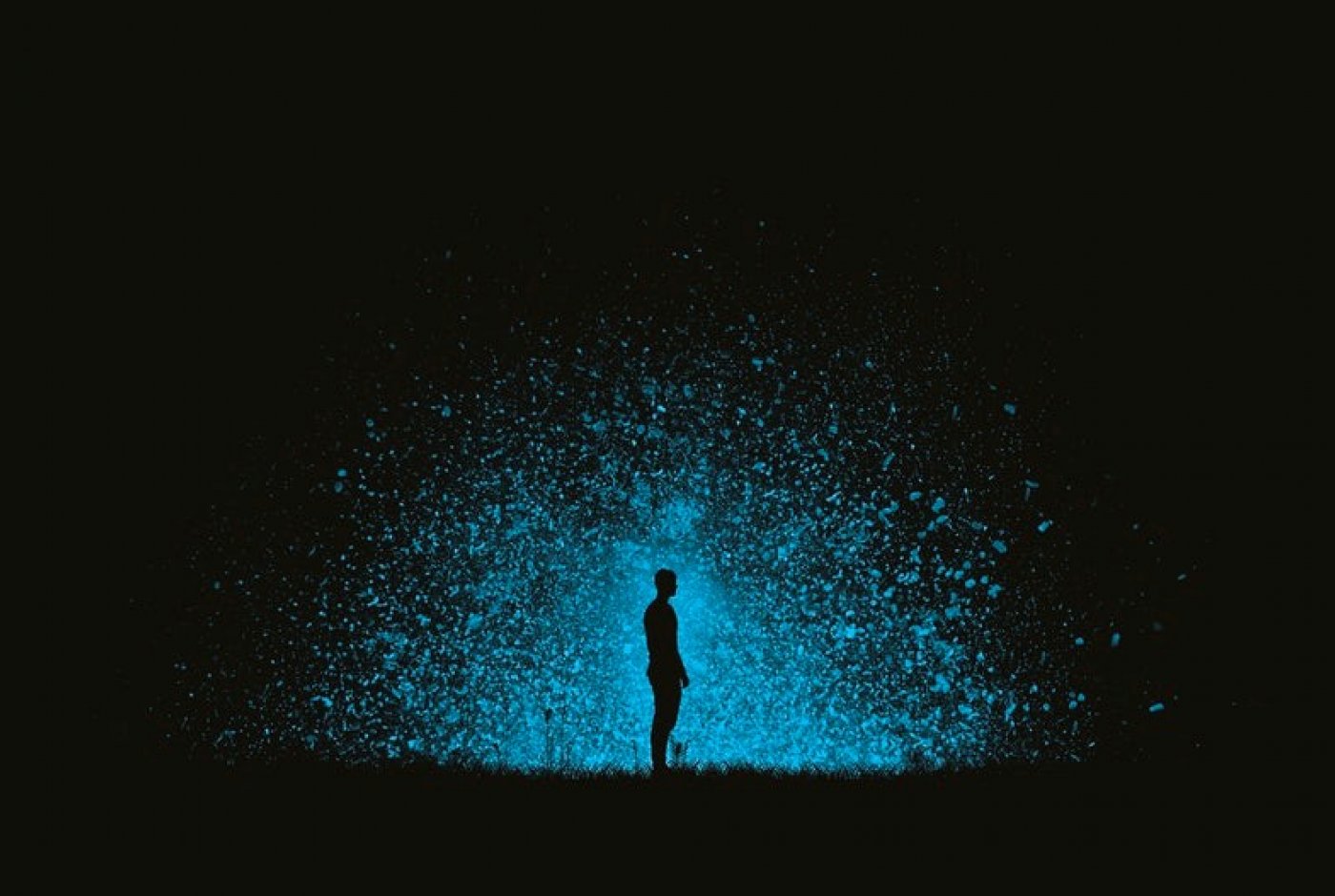 Human figure in blue light explosion