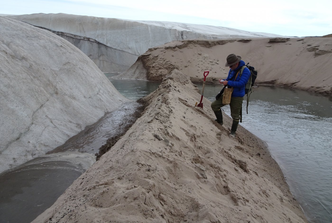 researcher collecting sand from meteorite