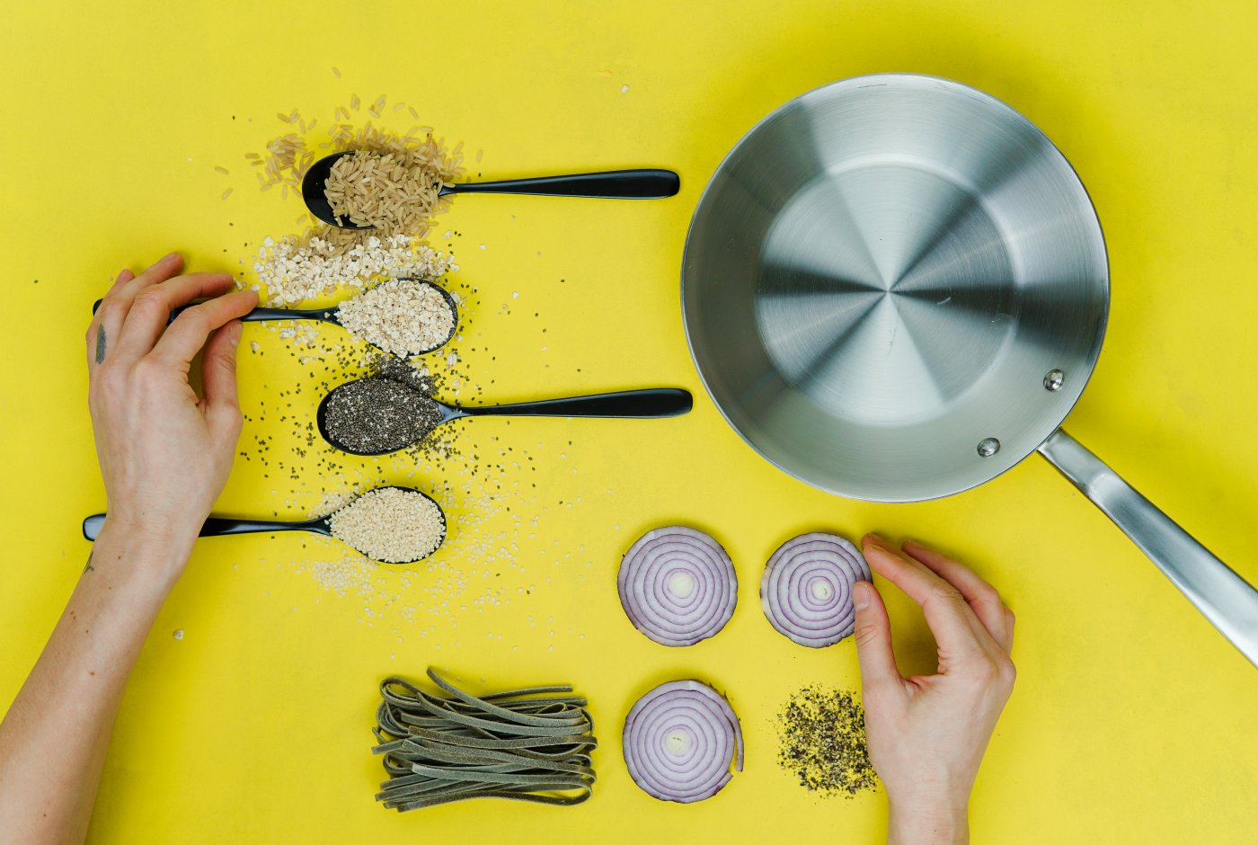 spoons with spices and a frying pan