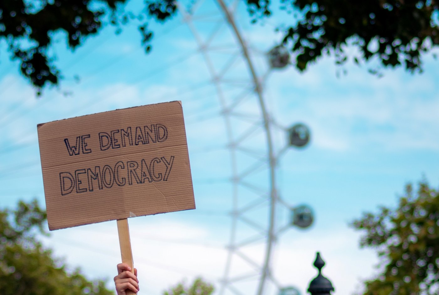 a poster that reads "we demand democracy"