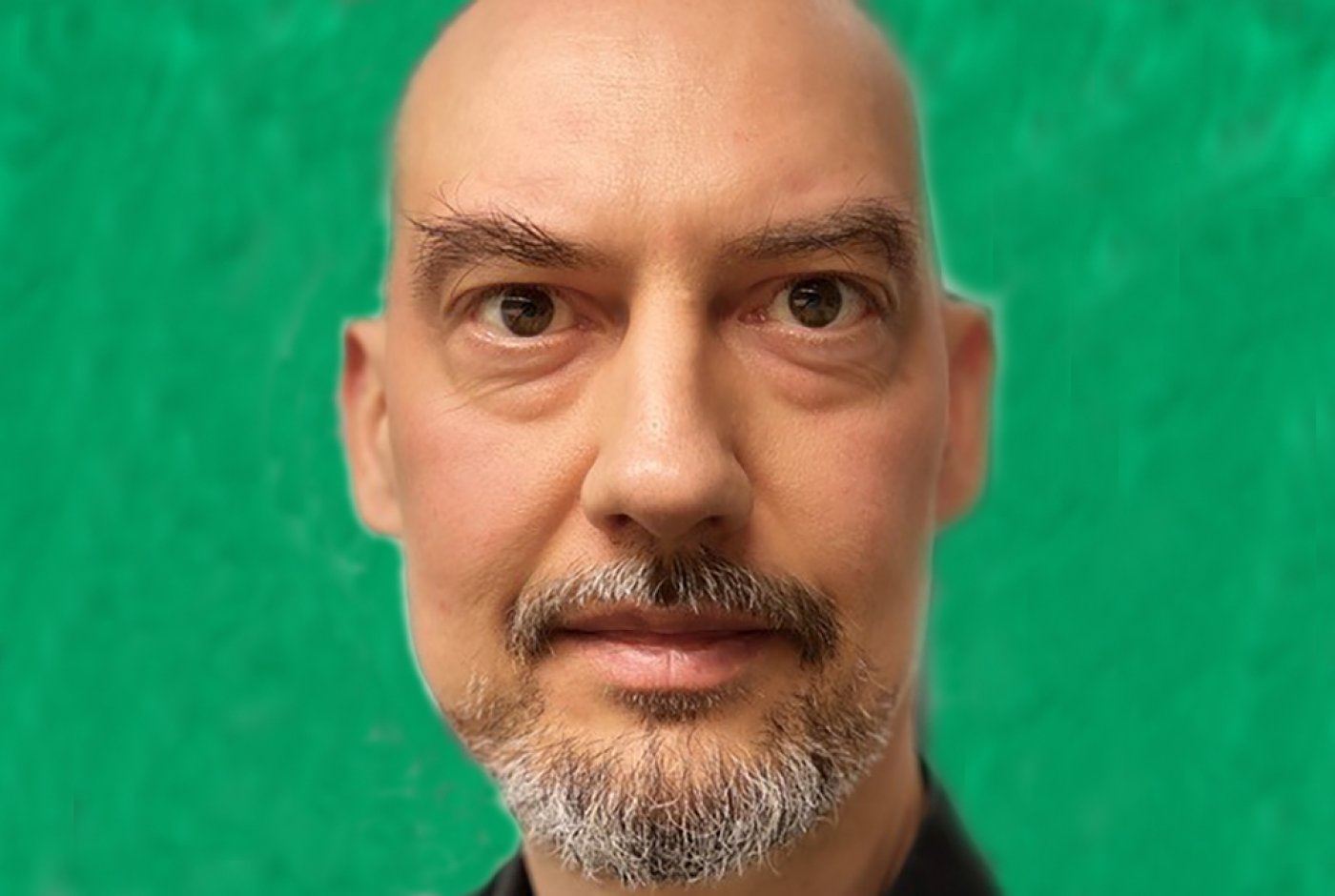 a bald guy staring at the camera
