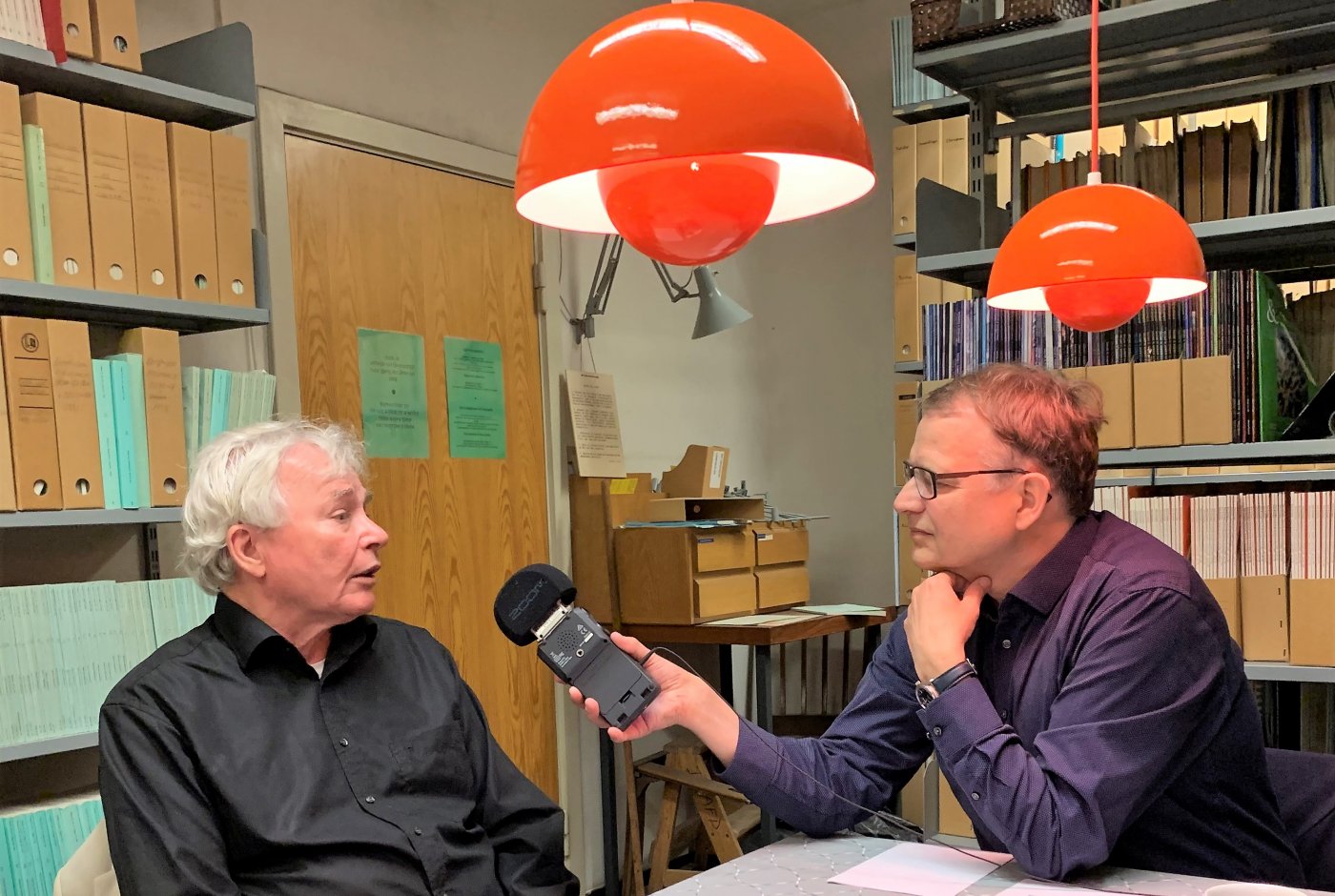 a man interviewing another man