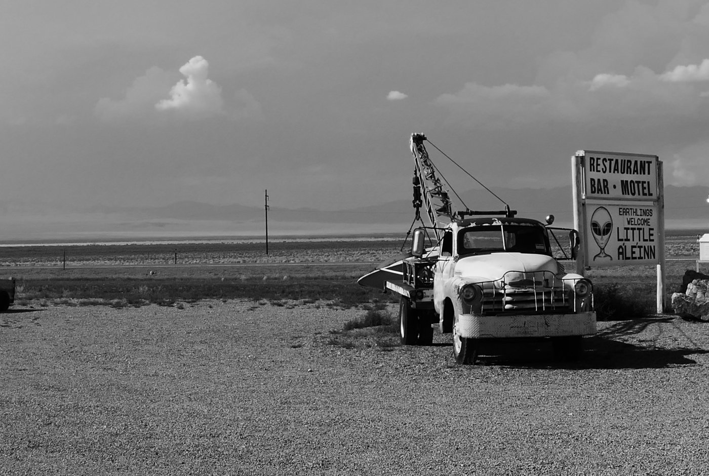 an old pickup and a alien sign