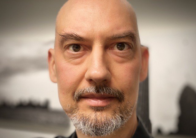 a bald guy staring at the camera