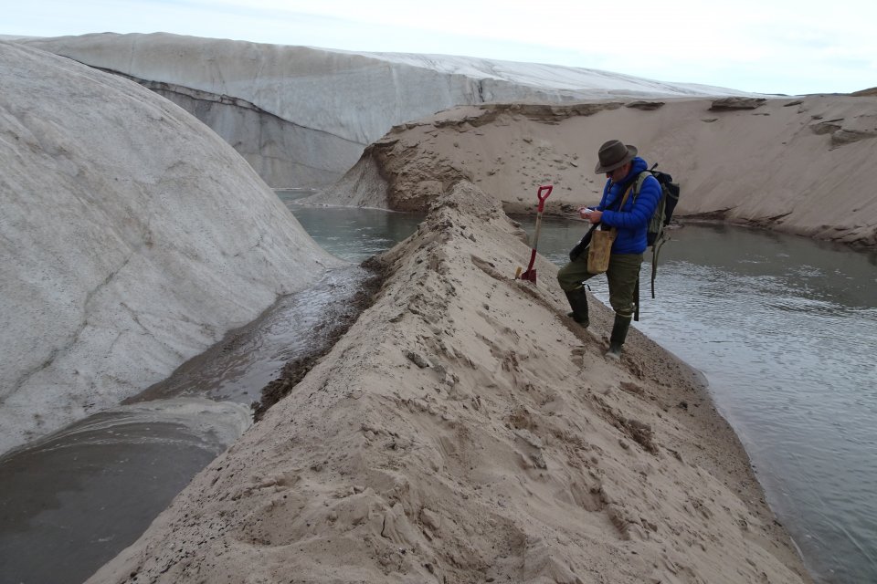 researcher collecting sand from meteorite