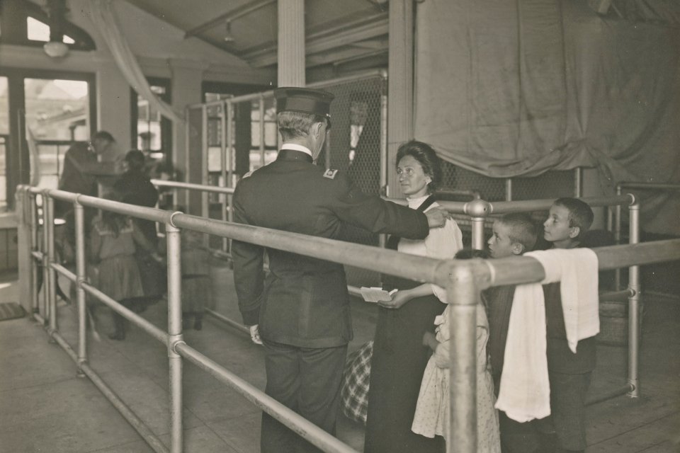 a police officer checking an women and her 3 children