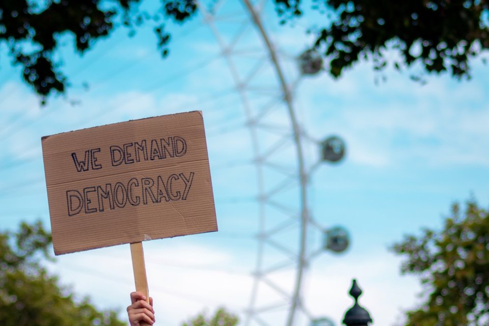 a poster that reads "we demand democracy"