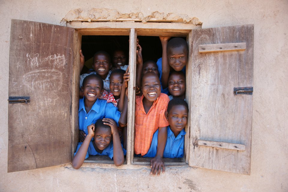 young African boys crowded in a window