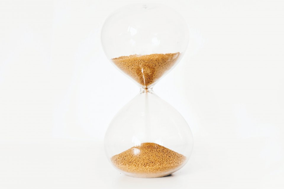 an hour glass with golden sand