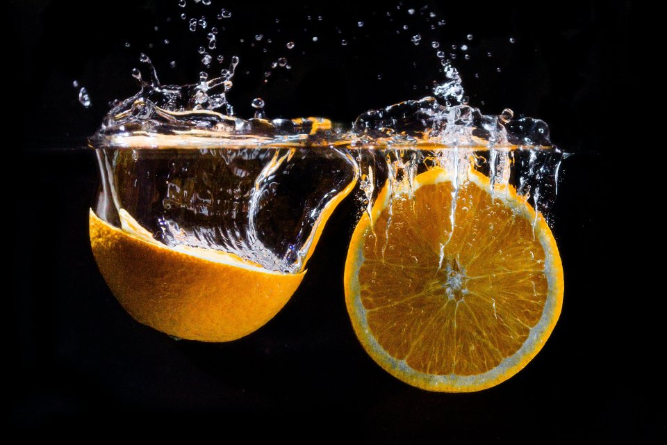 a split orange in water