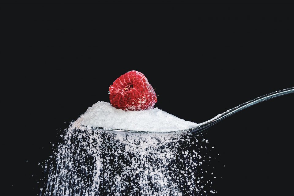 a spoon of sugar with a raspberry on top