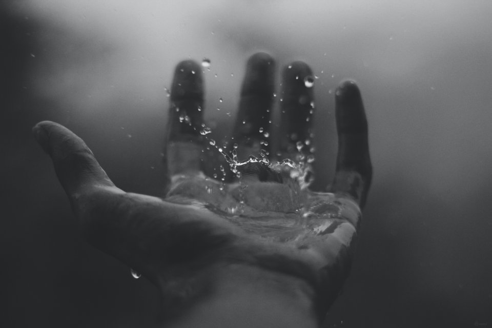 a hand with water splash