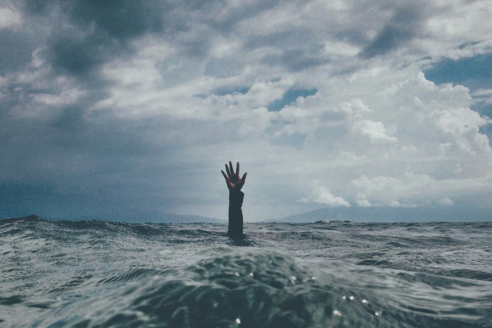 a hand in the middle of the sea