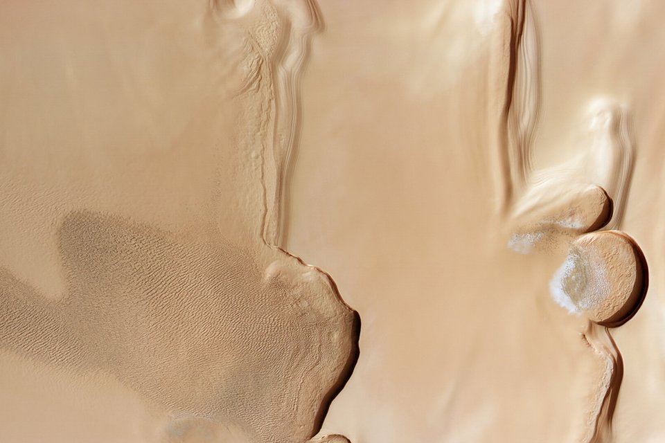 Sand dunes meet stacked ice at Mars’s north pole.